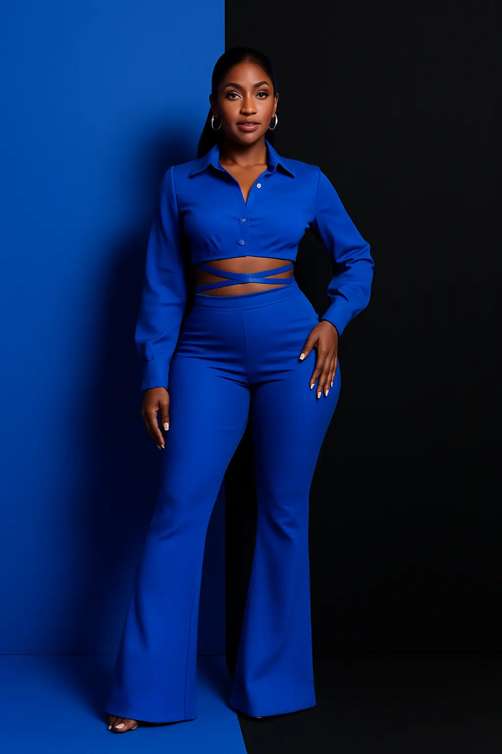 Woman wearing a blue outfit against a blue & black background
