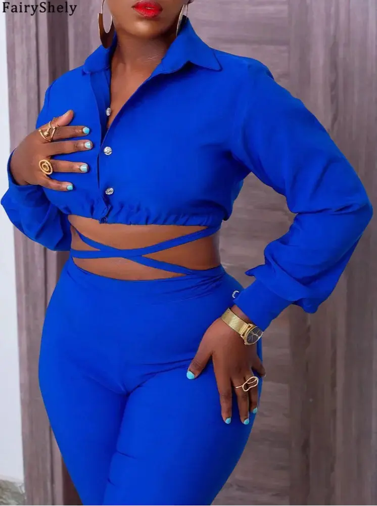 Woman wearing a blue outfit with cut-out design, posing against a neutral background.