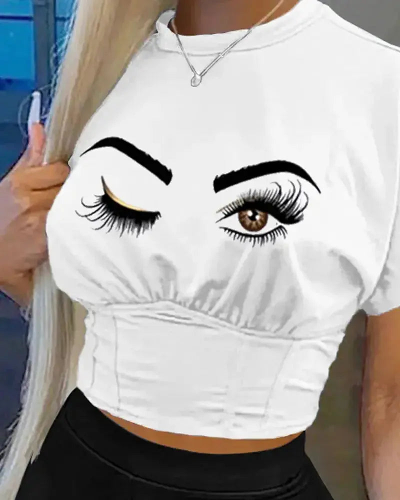 White crop top with eye and eyelash design worn by a person.
