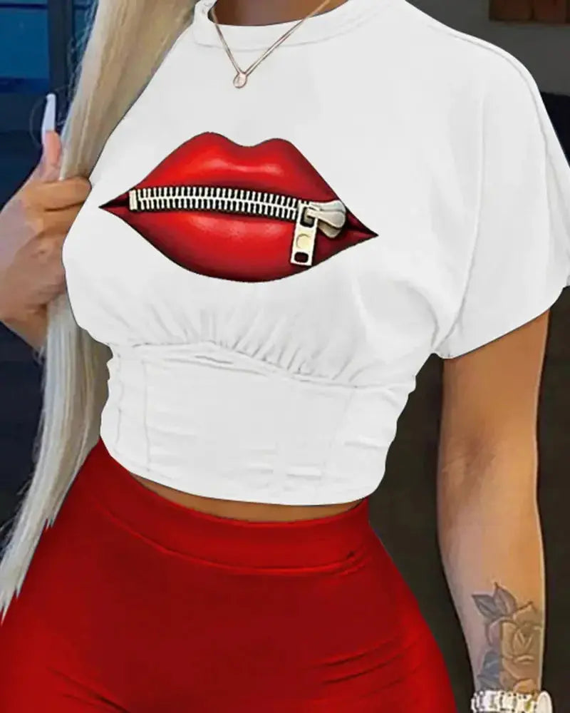 White crop top with red lips graphic design worn by a person.