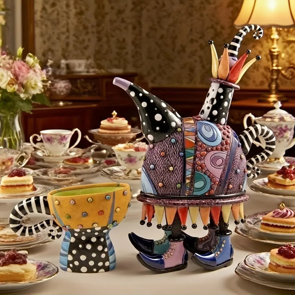 Colorful ceramic teapot on a table with tea set and pastries