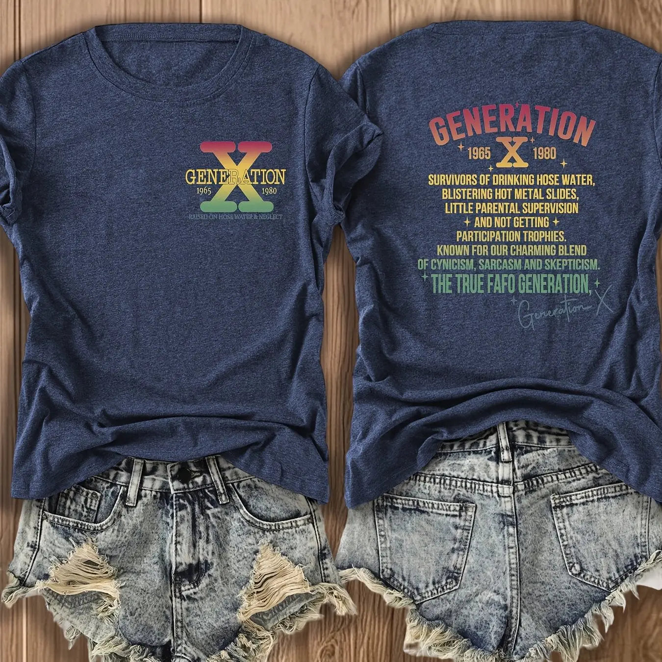 Blue t-shirt with 'Generation X' design on a wooden surface with denim shorts.