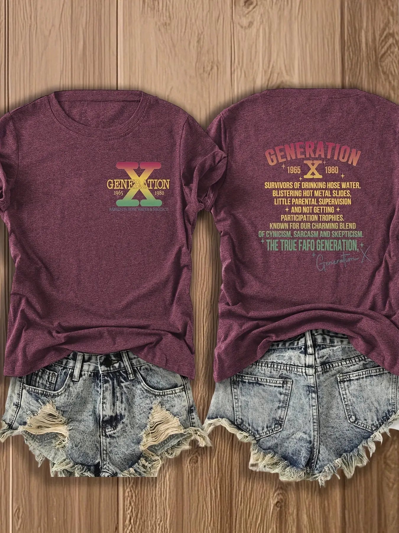 Maroon t-shirt with 'Generation X' design on a wooden surface