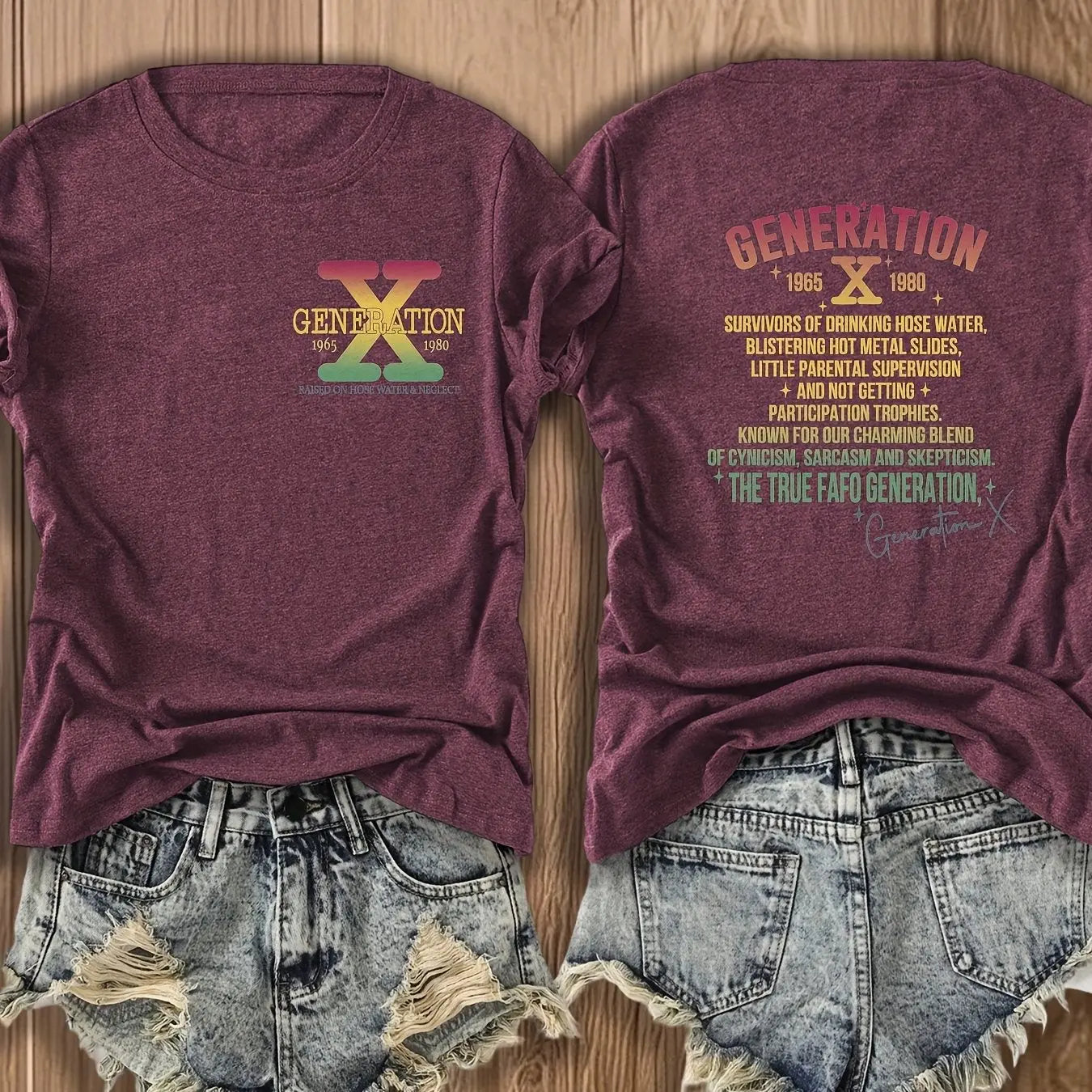 Maroon t-shirt with 'Generation X' logo and text on a wooden surface