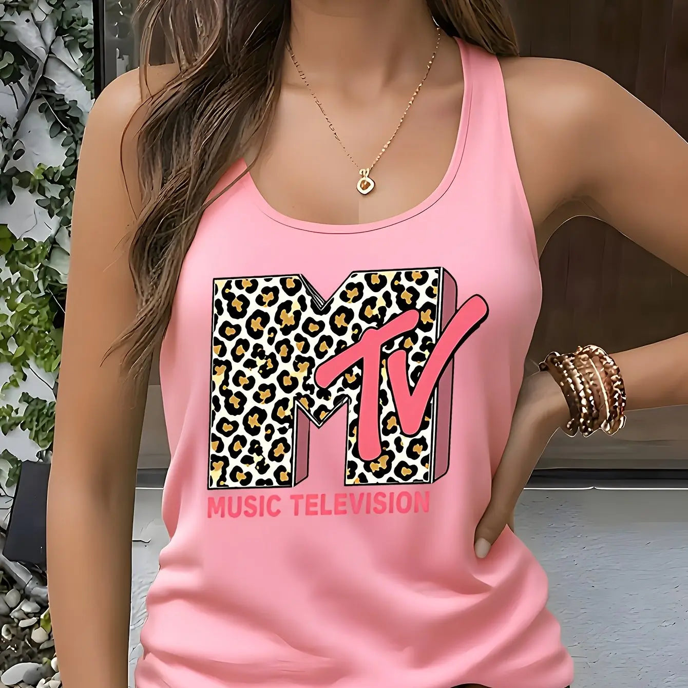 Model showcasing the Fantascticz 80s style racerback tank top in a soft light pink, featuring the iconic MTV Music Television logo with its classic leopard print design.