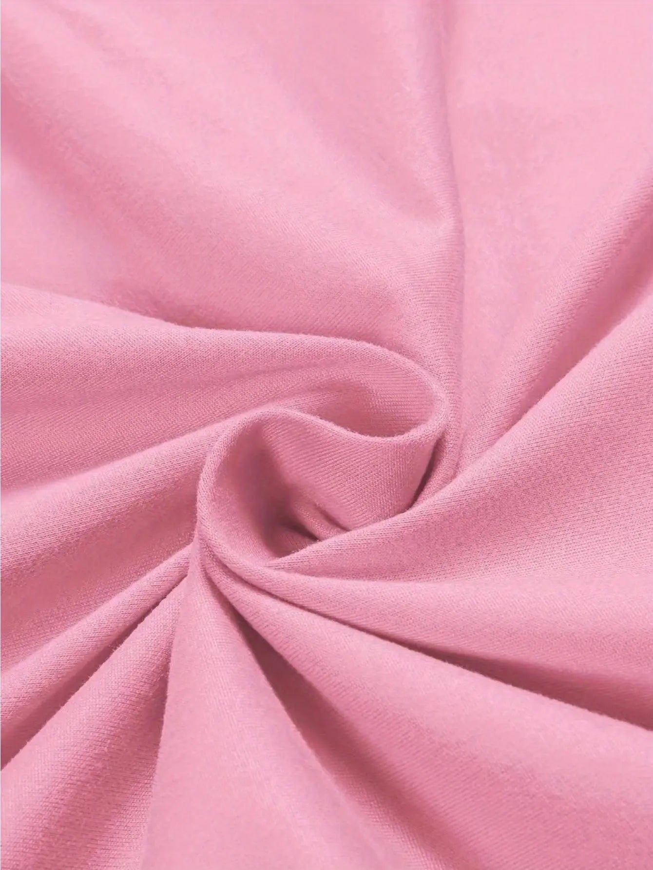 Detailed macro shot of the Fantascticz 80s style tank top's light pink fabric, highlighting its soft, breathable texture and premium quality material.