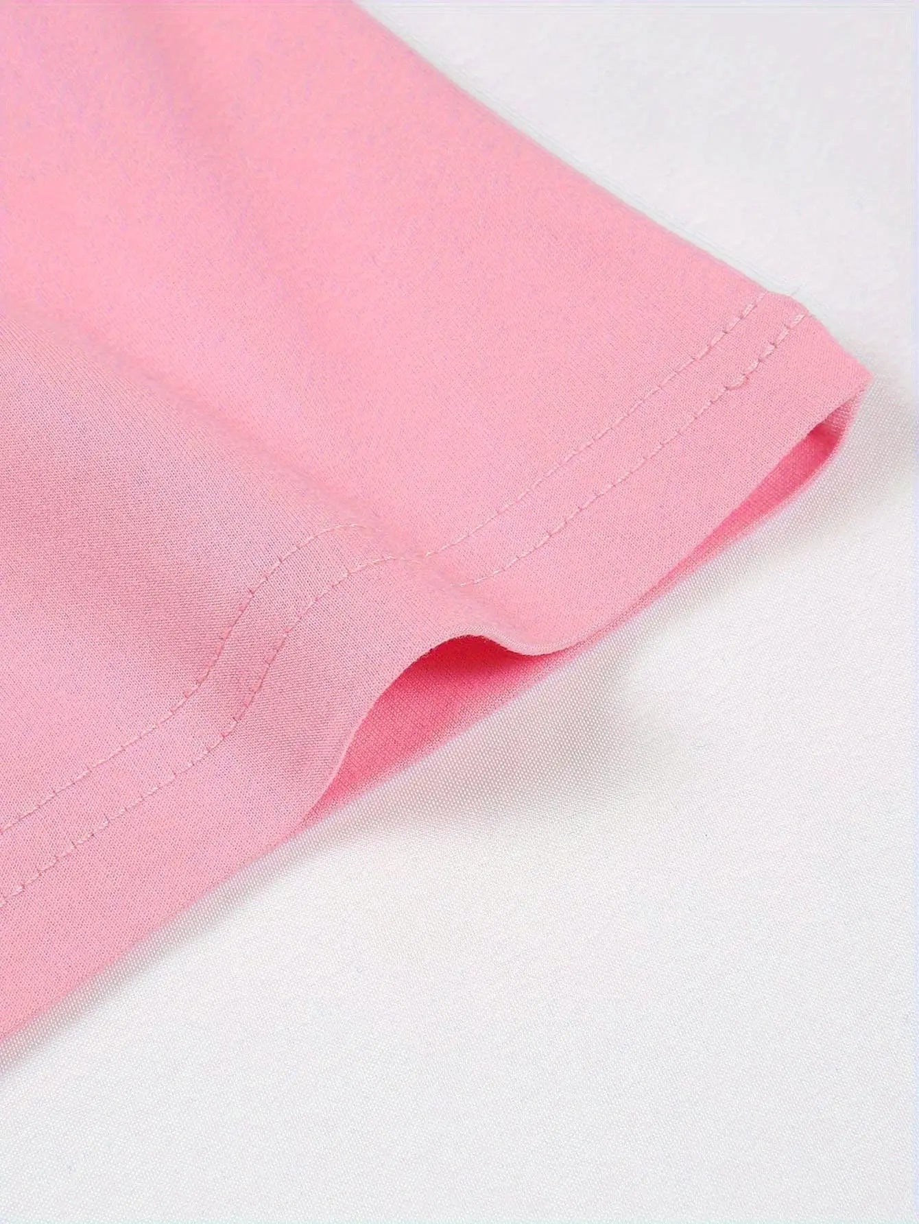 Detail shot of the Fantascticz 80s style tank top, highlighting the clean and durable double-stitching on the hemline. This view showcases the garment's high-quality construction.