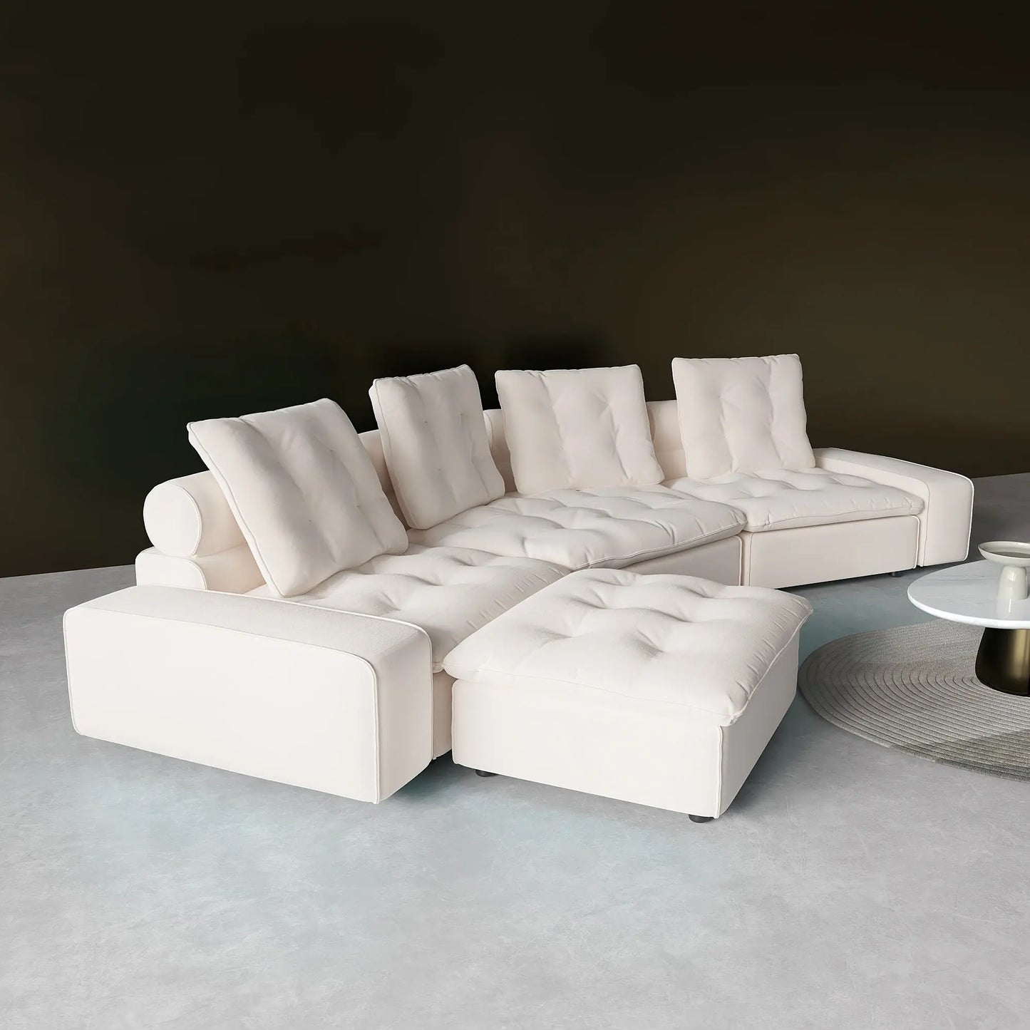 White sectional sofa in a minimalistic room with a dark wall and light floor.