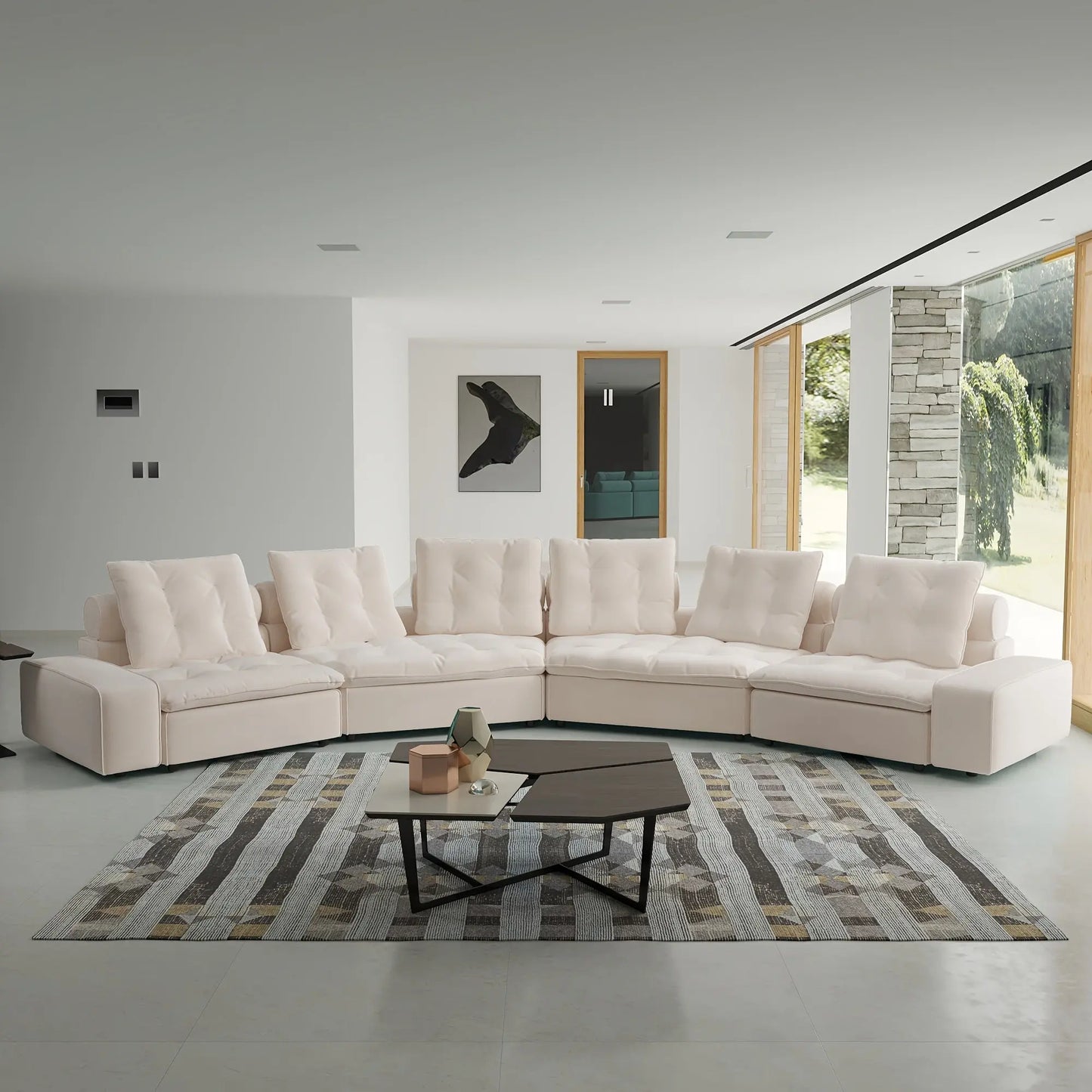 Modern living room with a beige sectional sofa, coffee table, and decorative elements.