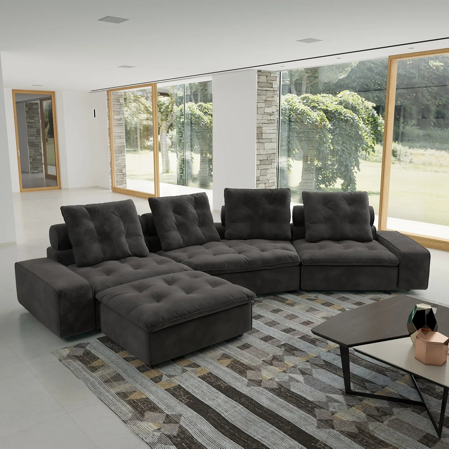 Gray sectional sofa in a modern living room with large windows.