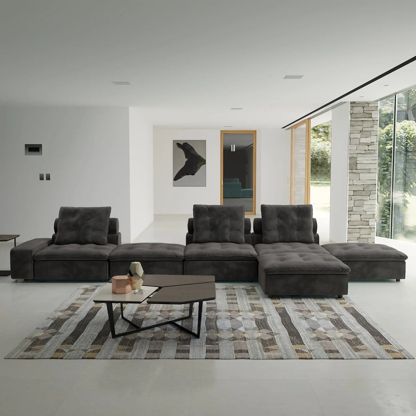 Modern living room with a gray sectional sofa, coffee table, and decorative items.