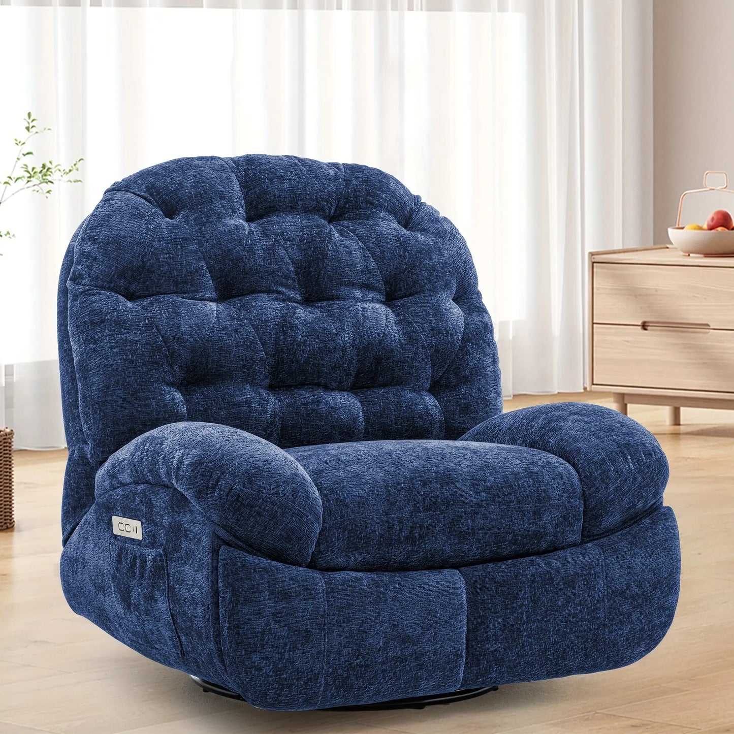 Blue plush armchair in a room with light-colored curtains and wooden furniture.