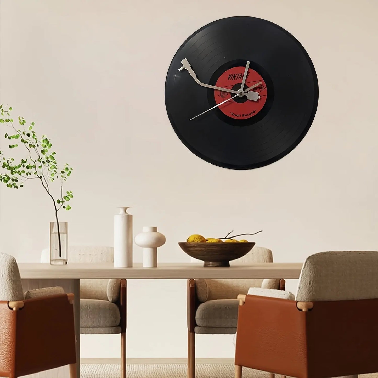 The Time Spinner Vinyl Record Clock by Fantascticz hangs as a statement piece of wall art above a modern dining table, adding a unique, retro touch to the room's decor.