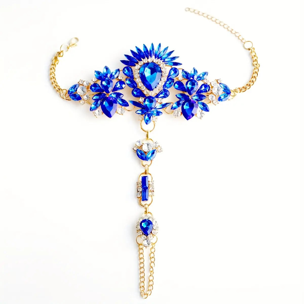 Product shot of The Empress barefoot sandals in sapphire blue, featuring a gold-tone setting and clear crystal accents on a white background.