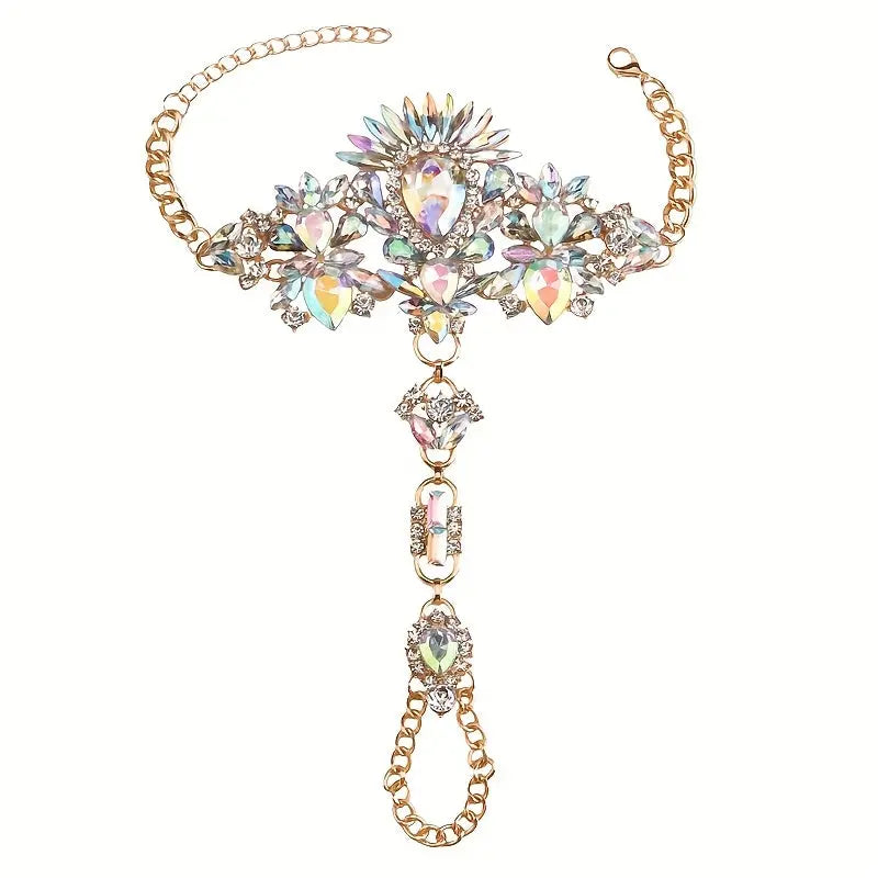 Product shot of The Solaris barefoot sandals with iridescent crystals, featuring a sunburst ankle cuff and a light gold-tone setting on a white background.