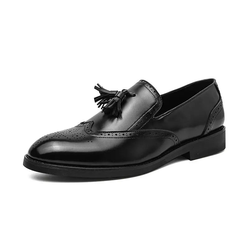 Profile view of The Strummer men's brogue loafer in high-gloss black leather, showing the tassel and intricate wing tip detailing.