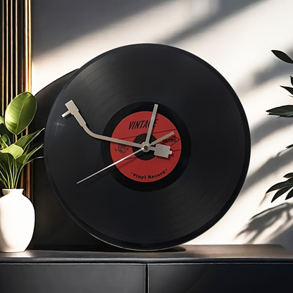 Vinyl record clock on a surface with plants in the background