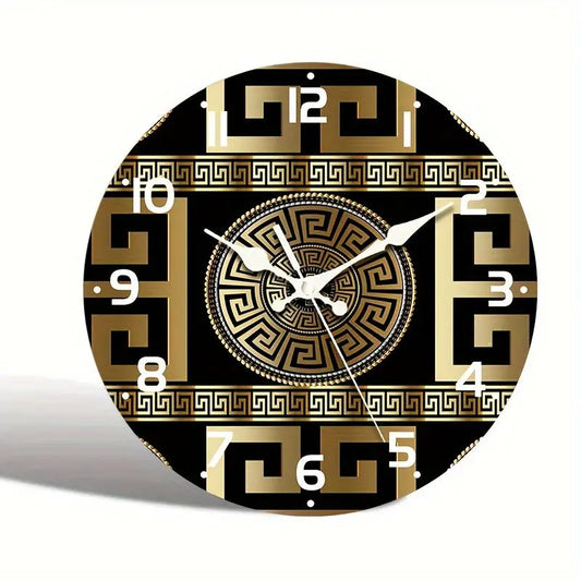 Decorative wall clock with gold and black pattern on a white background