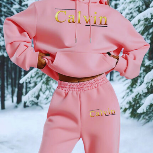 Pink 'Calvin' tracksuit worn by a person in a snowy forest setting