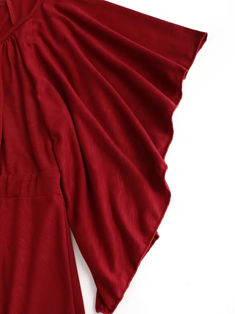 Red fabric with a draped effect on a white background