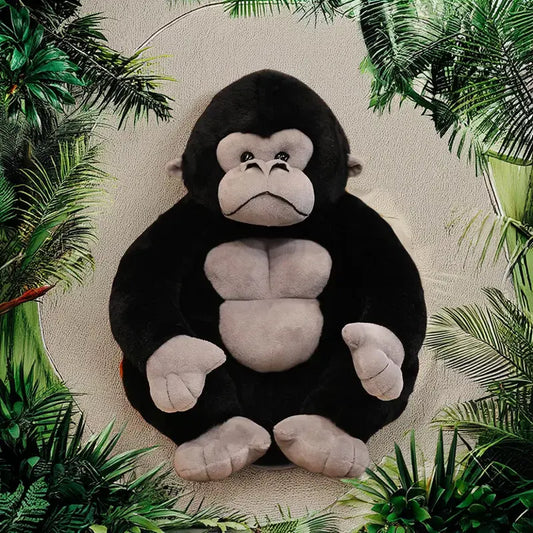 Plush monkey toy surrounded by green foliage
