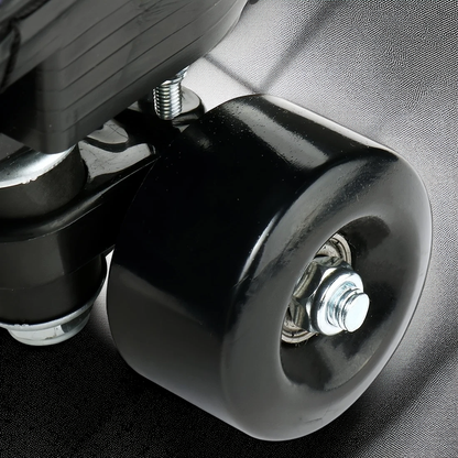 Close-up of a black wheel with metal bearings on a textured surface