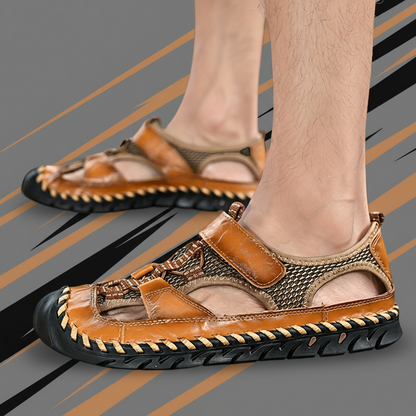 Brown sandals worn by a person on a gray background with orange and black stripes