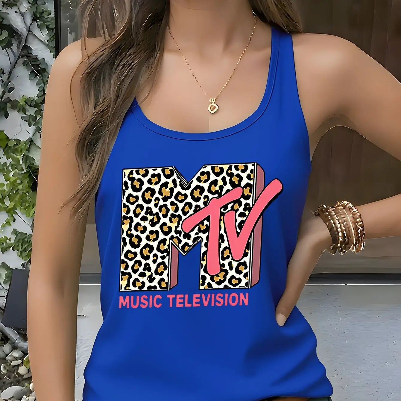 Model wearing the Fantascticz 80s style racerback tank top in a stunning royal blue, highlighting the iconic MTV Music Television logo with its bold leopard print design.