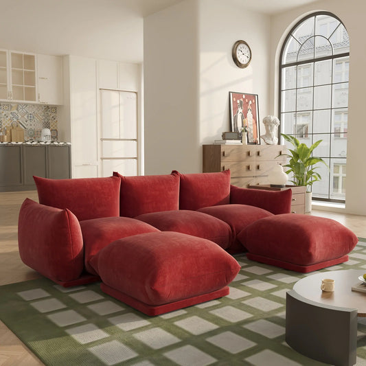The Fantascticz Nexus Modular Sectional Sofa in rich Red Chenille fabric, arranged in a spacious, modern living room with a large arched window.