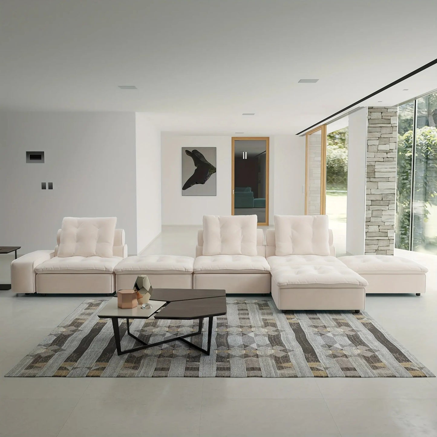 Modern living room with a white sectional sofa, coffee table, and decorative elements.