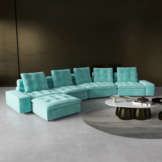 Turquoise sectional sofa in a modern living room setting with a round coffee table.