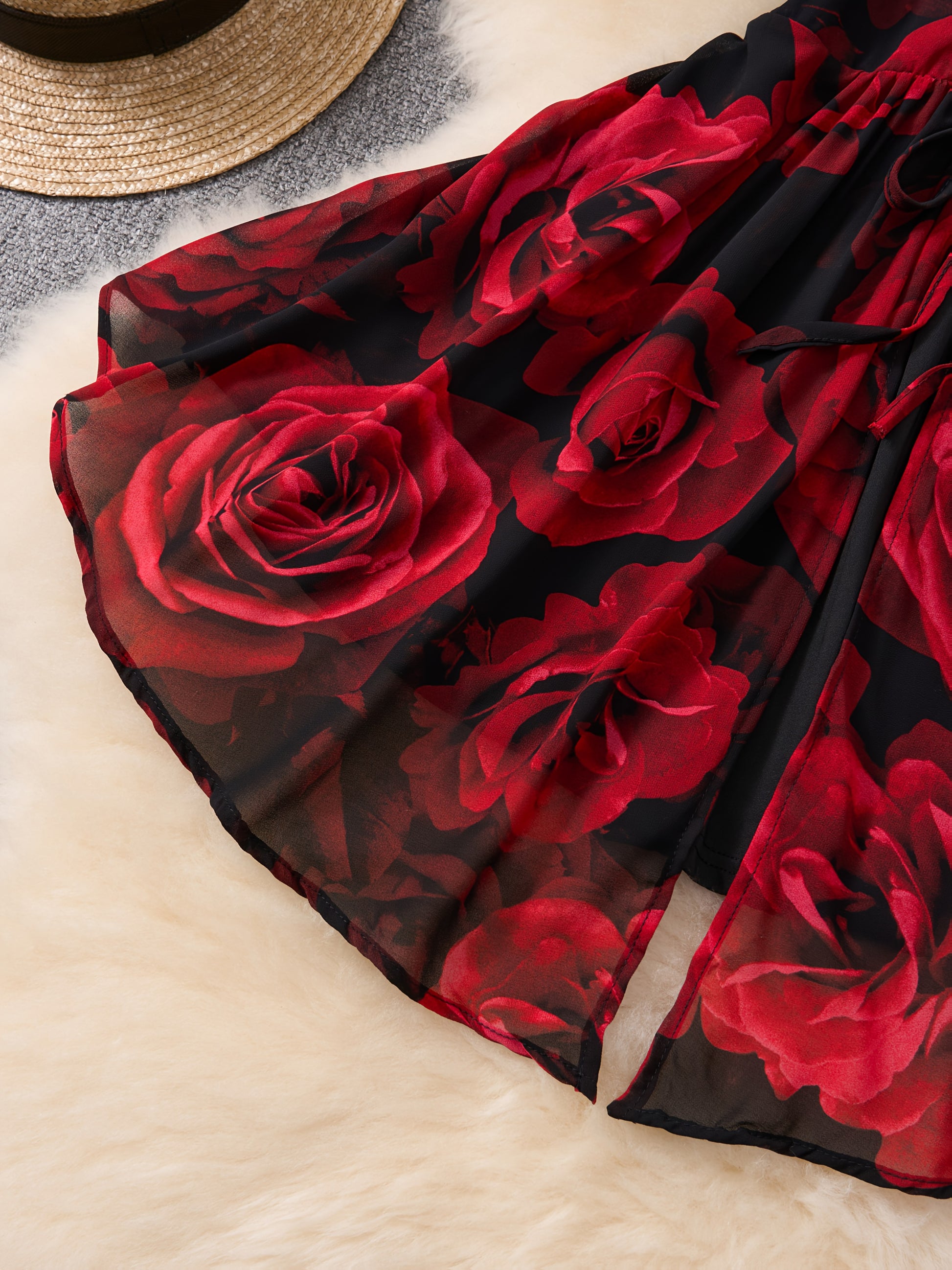 Red rose patterned fabric on a textured surface