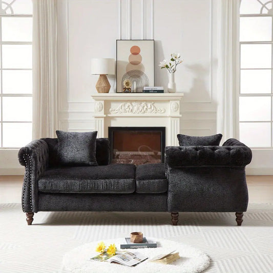 Dark gray sofa in a living room with a fireplace and decorative items.