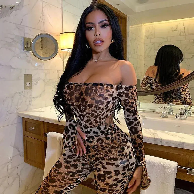 Woman in a leopard print outfit standing in a bathroom.