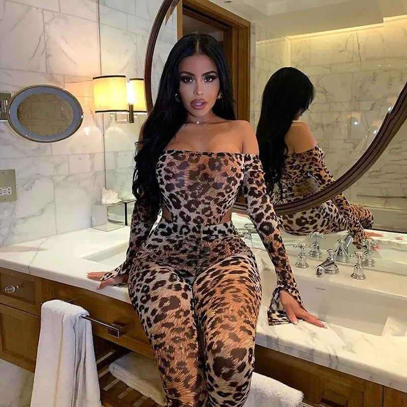 Woman in leopard print outfit posing in a bathroom.