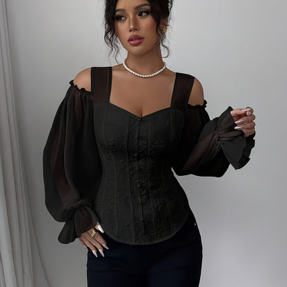A woman wearing a black off-shoulder corset style top with wide straps, with a plain background